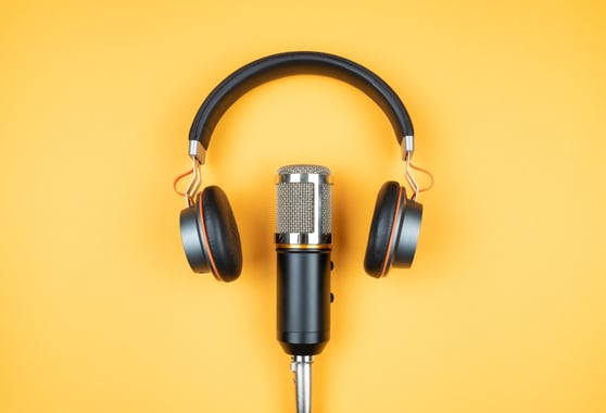 Headset and microphone on a yellow background.