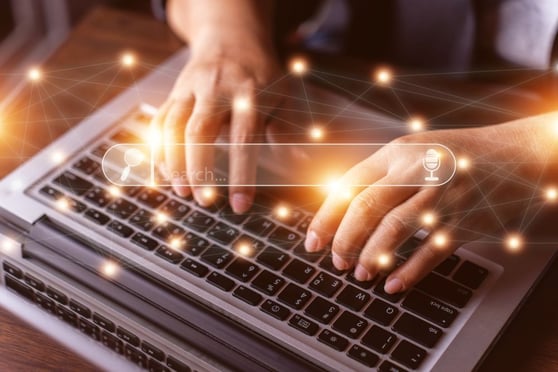 Person using the internet to search for information on laptop.