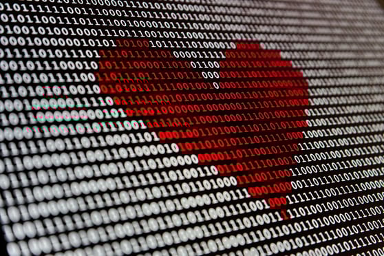 Binary code forming a heart shape symbolizing data-driven personalization in AI and marketing automation.