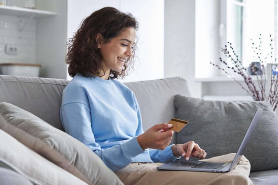 Woman shopping online with a credit card, an example of customer behavior for Amazon ad types.